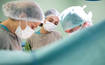 Focused medical team performing surgery in a sterile operating room environment with precision and care.