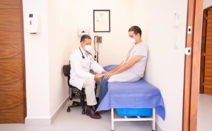 Doctor checking patient's vitals in a clinical setting for health consultation.