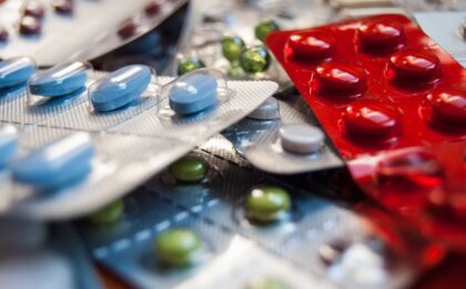 Close-up of various colored medication pills in blister packs.