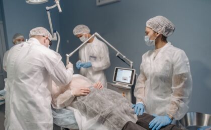 Healthcare professionals conducting a laser surgical procedure in a clinic setting.
